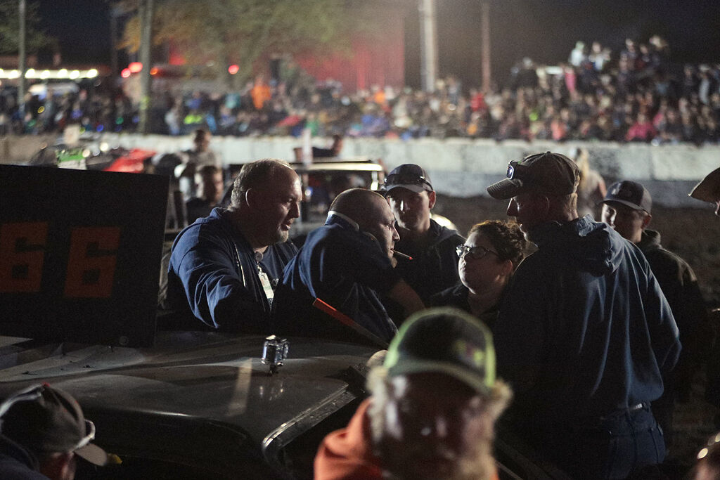Medics and fans help Derek Ranks out of his demolition car